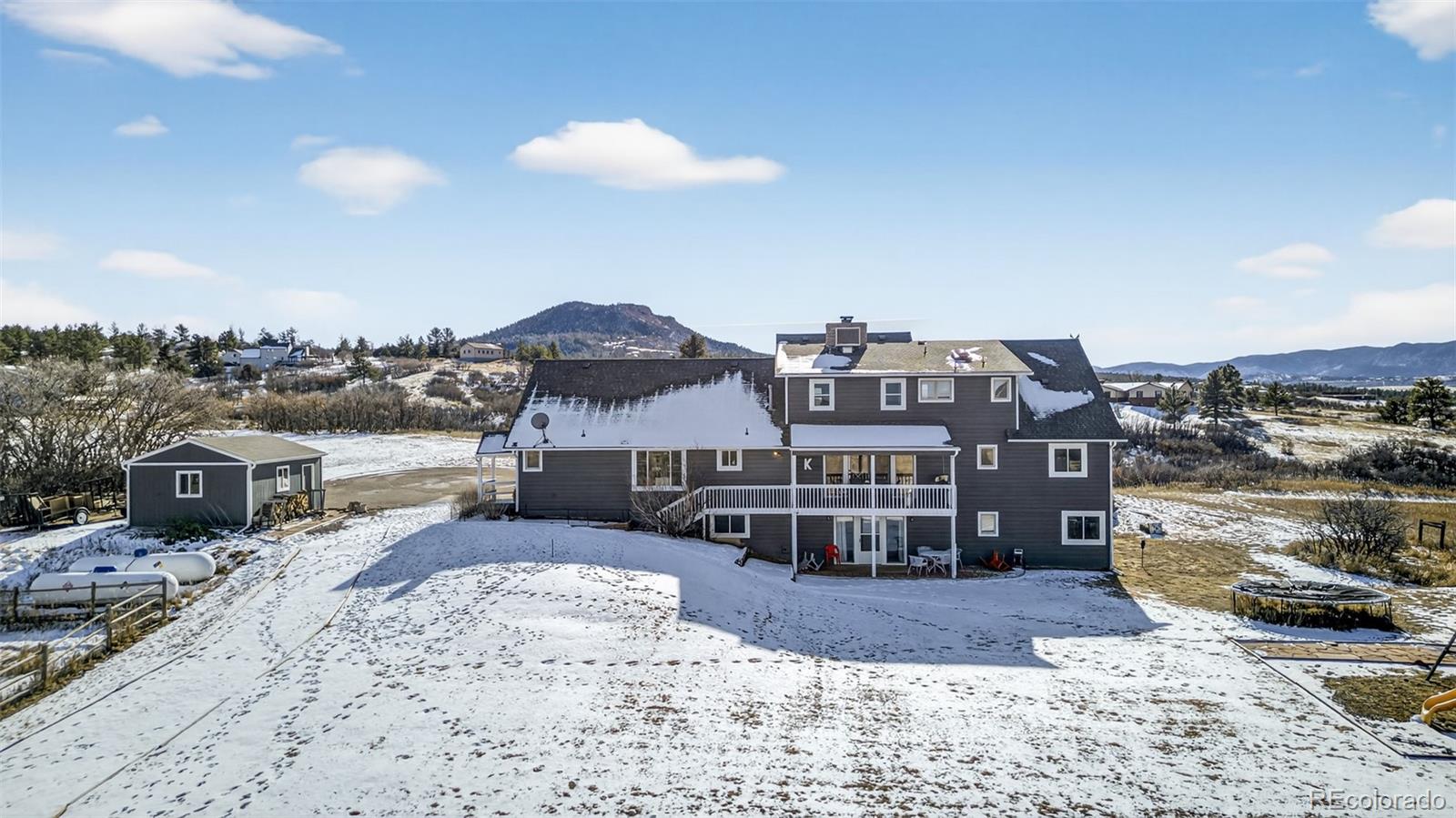 4205 West Parkridge Road Sedalia, CO 80135 - Photo 6 of 50 a view of a house with a yard and sitting area