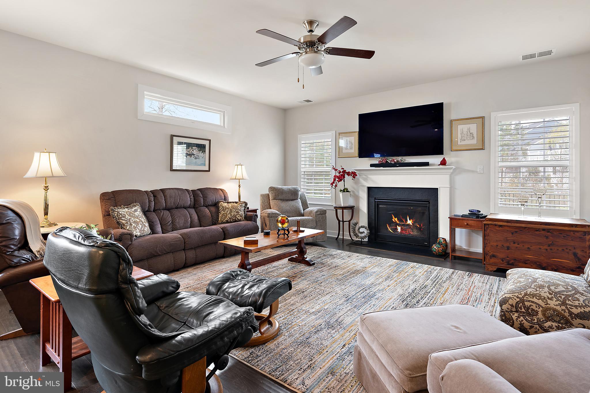 8 Old Forge Drive Ocean View, DE 19970 - Photo 13 of 103 a living room with furniture a flat screen tv and a fireplace