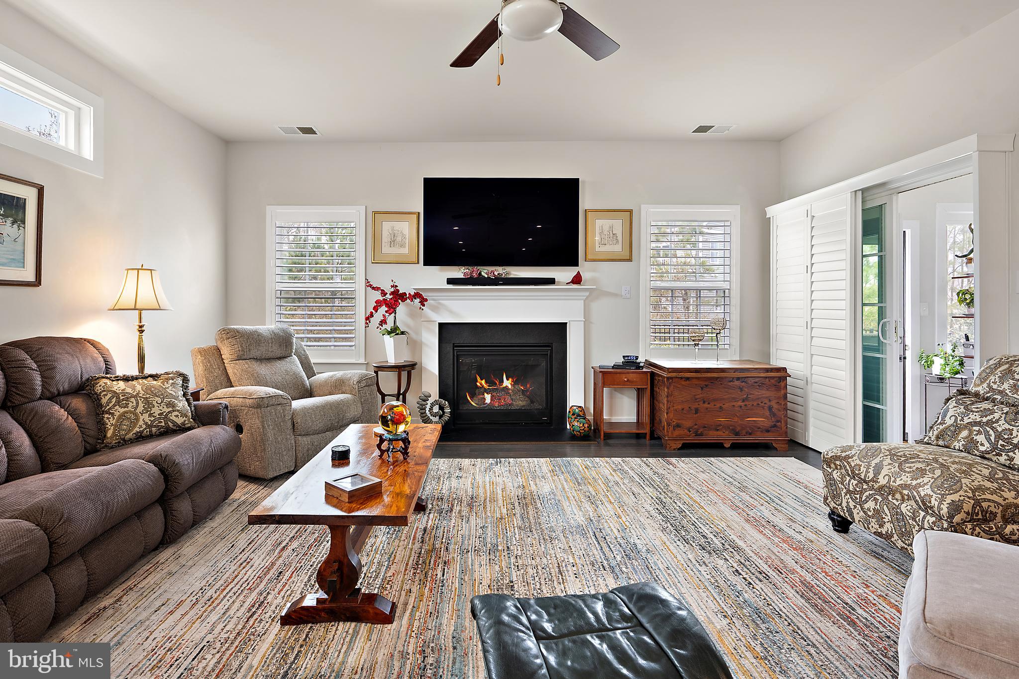 8 Old Forge Drive Ocean View, DE 19970 - Photo 15 of 103 a living room with furniture a flat screen tv and a fireplace