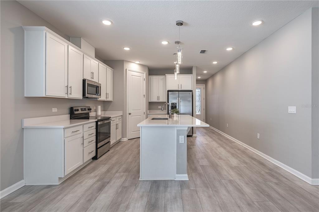 10361 Church Hammock Road Leesburg, FL 34788 - Photo 14 of 46 a kitchen with a sink stainless steel appliances and cabinets