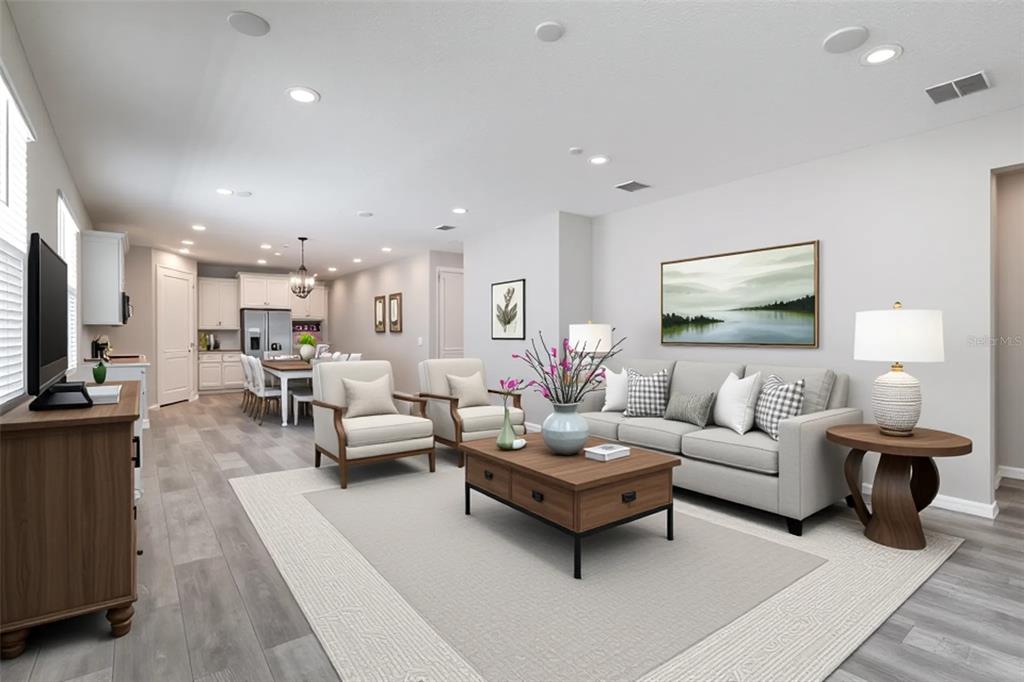 10361 Church Hammock Road Leesburg, FL 34788 - Photo 17 of 46 a living room with furniture kitchen view and a flat screen tv