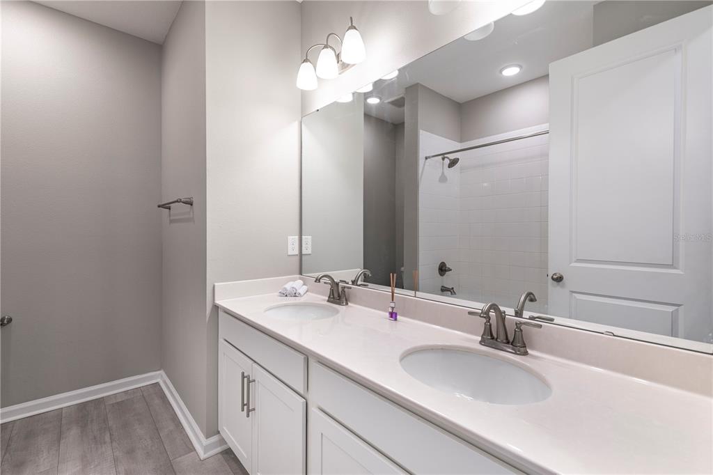 10361 Church Hammock Road Leesburg, FL 34788 - Photo 26 of 46 a bathroom with a sink vanity and a mirror