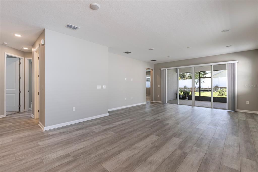 10361 Church Hammock Road Leesburg, FL 34788 - Photo 35 of 46 a view of an empty room with wooden floor and a window