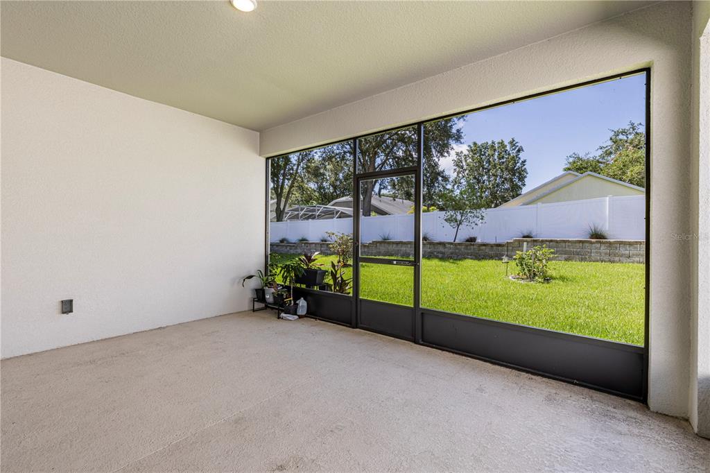 10361 Church Hammock Road Leesburg, FL 34788 - Photo 36 of 46 a view of an empty room with a floor to ceiling window
