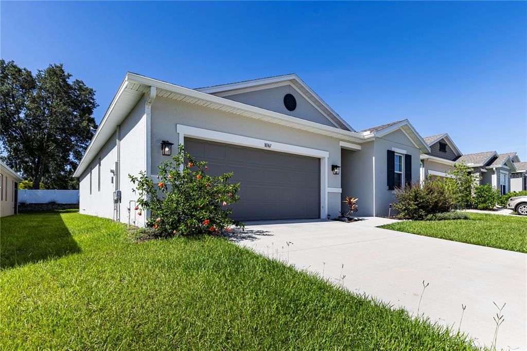 10361 Church Hammock Road Leesburg, FL 34788 - Photo 6 of 46 a front view of a house with a yard and garage