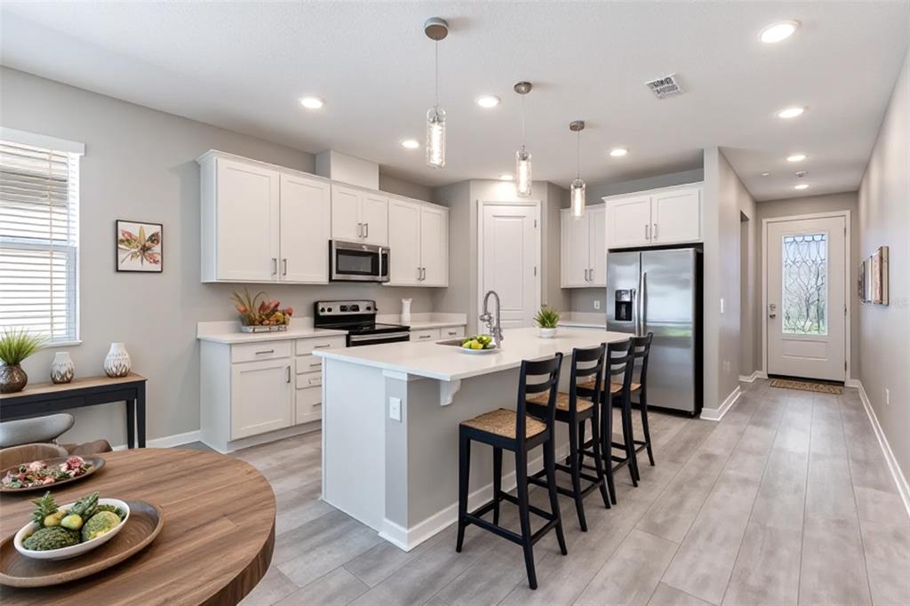 10361 Church Hammock Road Leesburg, FL 34788 - Photo 9 of 46 a kitchen with a table and chairs in it