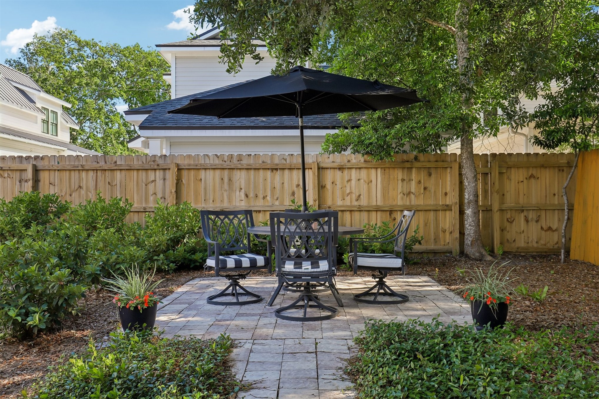 1012 White Street Fernandina Beach, FL 32034 - Photo 33 of 35 a view of a patio with chairs potted plants and a small yard