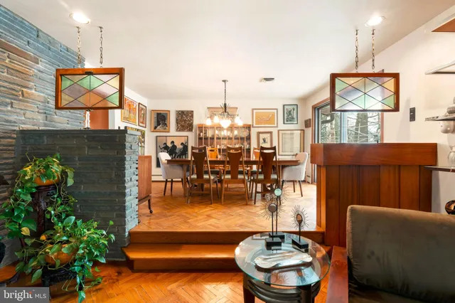 a dining room filled with furniture and a floor to ceiling window