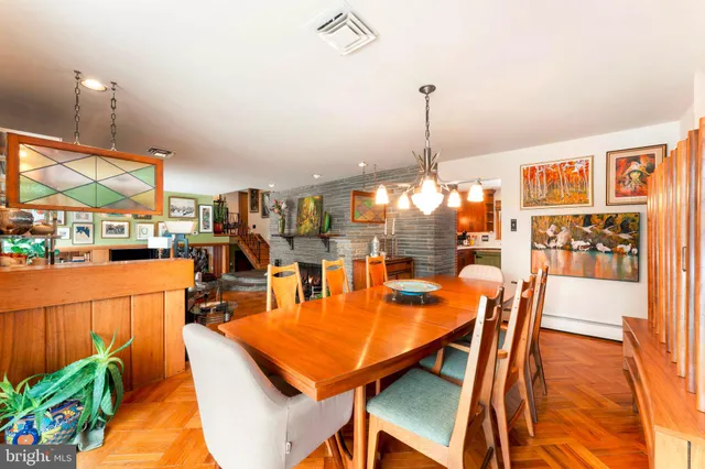 a view of a dining room with furniture and chandelier