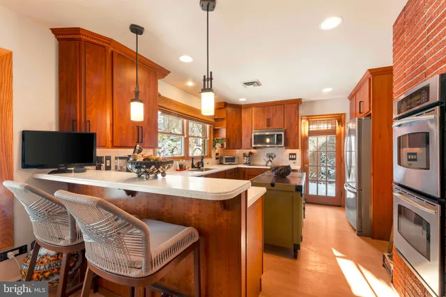 a kitchen with stainless steel appliances granite countertop a sink refrigerator and microwave