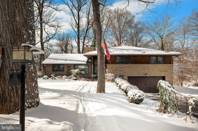 a front view of a house with yard and seating space