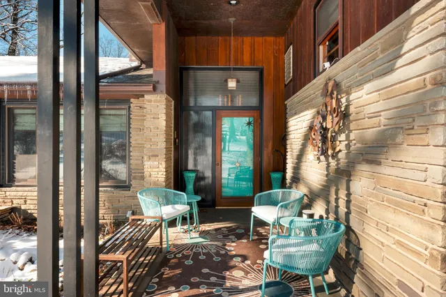 a view of balcony with two chairs and a potted plant