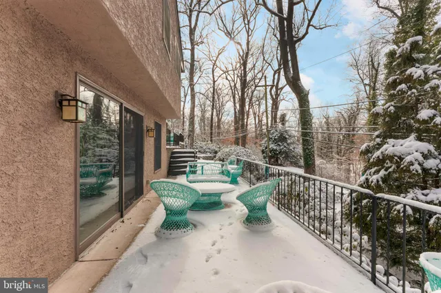 a view of a chair and table in backyard with potted plants