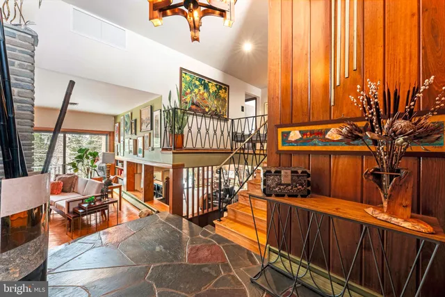 a view of entryway and hall with wooden floor