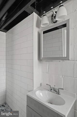 a view of an empty room with wooden floor and stairs