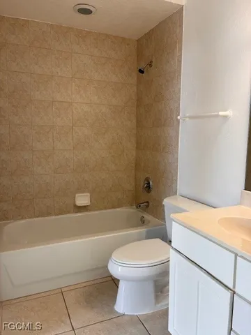 an empty room and a bathroom with a sink