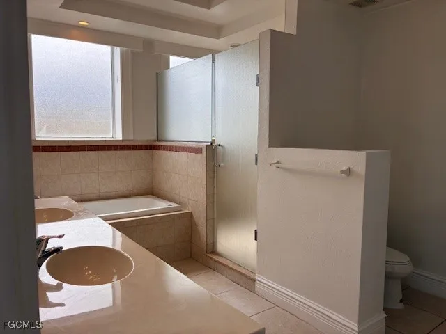 a kitchen with granite countertop a sink refrigerator and cabinets