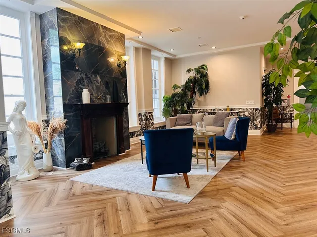 a living room with furniture a flat screen tv and a fireplace