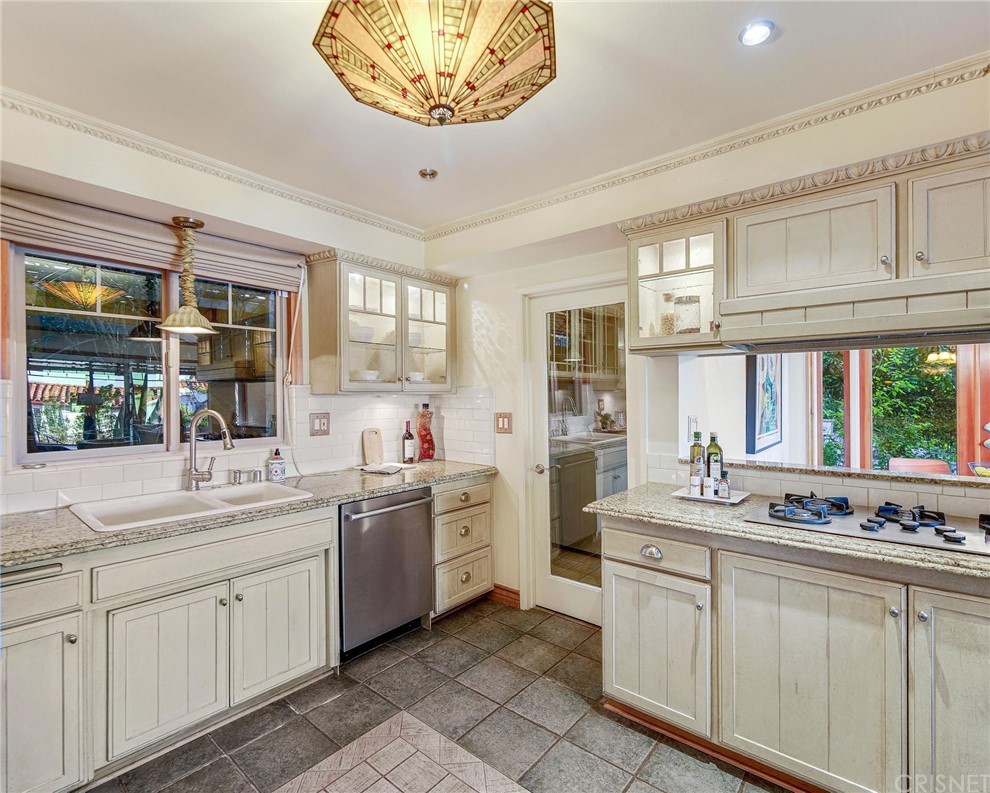 15098 Rayneta Drive Sherman Oaks, CA 91403 - Photo 15 of 43 a kitchen with a sink stove and cabinets