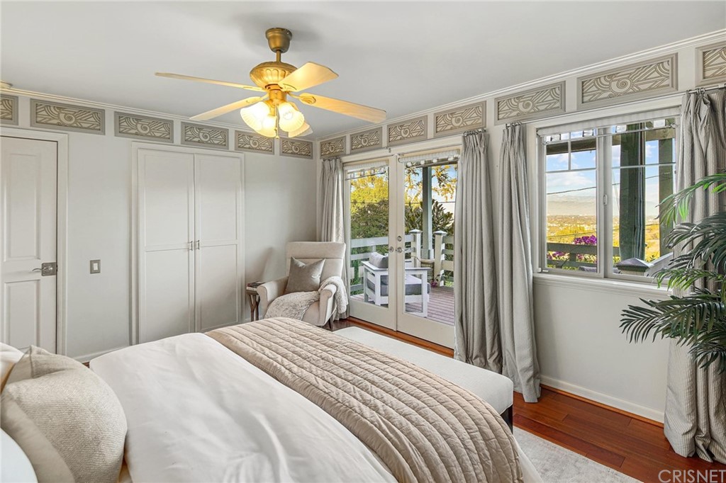 15098 Rayneta Drive Sherman Oaks, CA 91403 - Photo 20 of 43 a bedroom with a bed and a chandelier