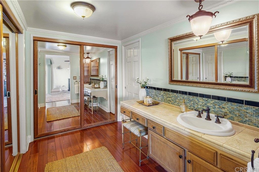 15098 Rayneta Drive Sherman Oaks, CA 91403 - Photo 23 of 43 a bathroom with a sink and a mirror