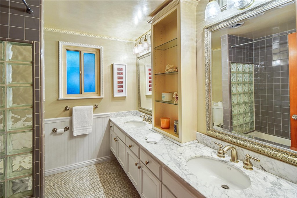 15098 Rayneta Drive Sherman Oaks, CA 91403 - Photo 28 of 43 a bathroom with a granite countertop sink mirror and double
