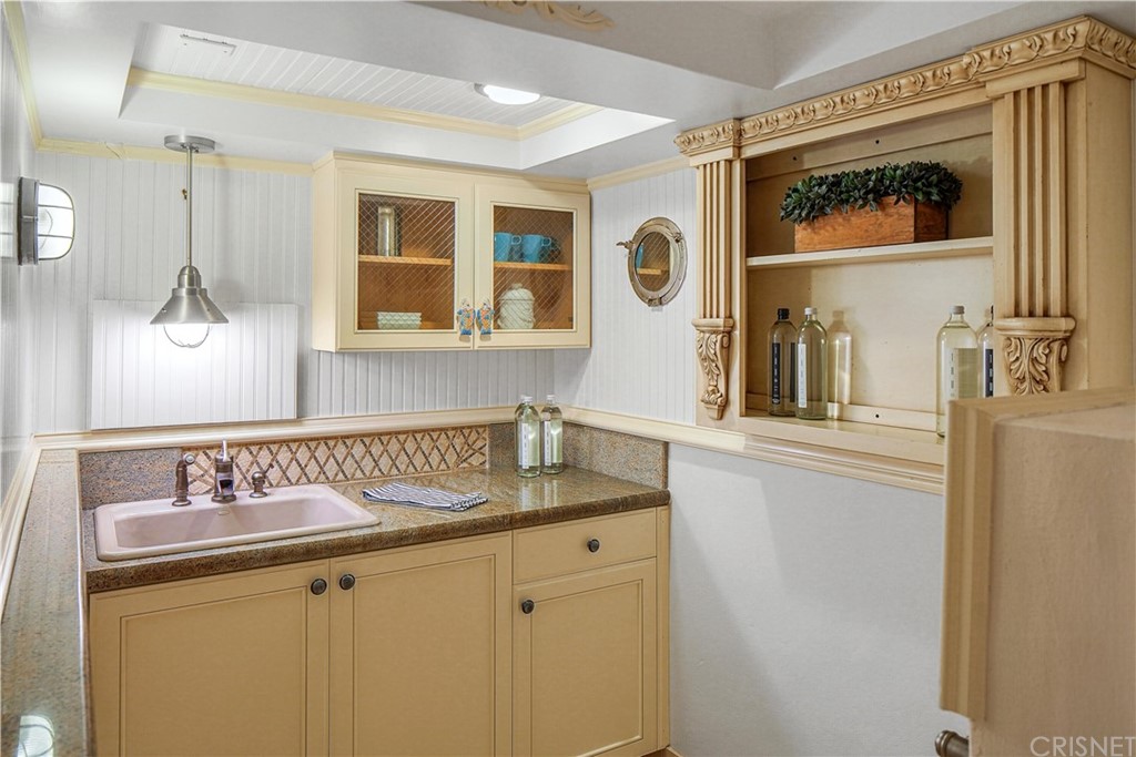 15098 Rayneta Drive Sherman Oaks, CA 91403 - Photo 30 of 43 a bathroom with a sink and a mirror