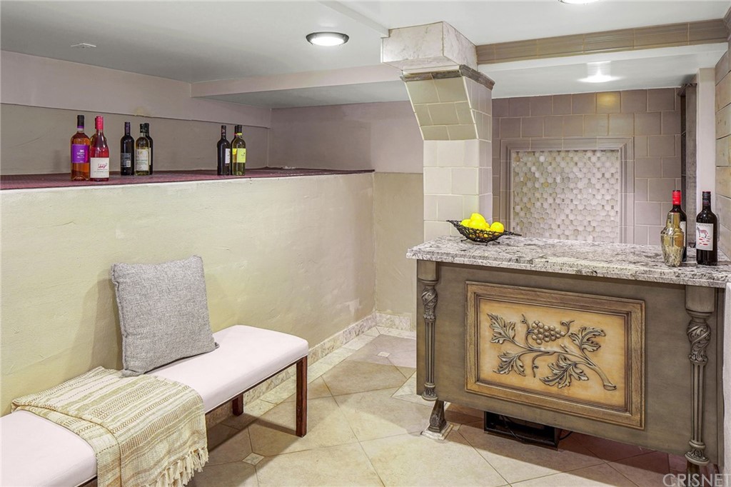 15098 Rayneta Drive Sherman Oaks, CA 91403 - Photo 32 of 43 a bathroom with a toilet a sink and a mirror