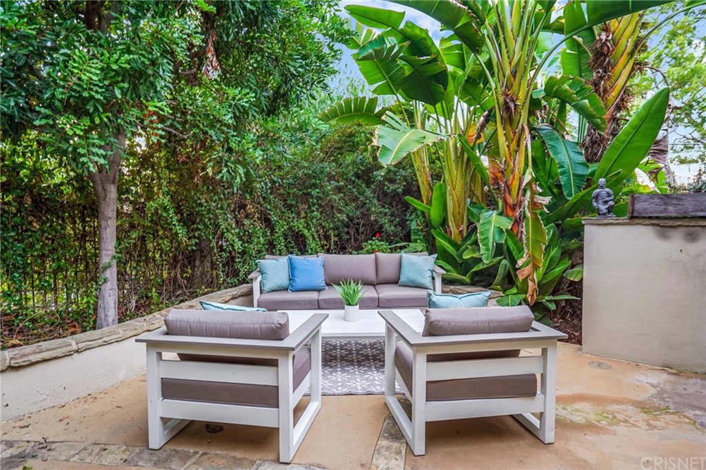 15098 Rayneta Drive Sherman Oaks, CA 91403 - Photo 39 of 43 a view of a patio with a table chairs and a potted plant