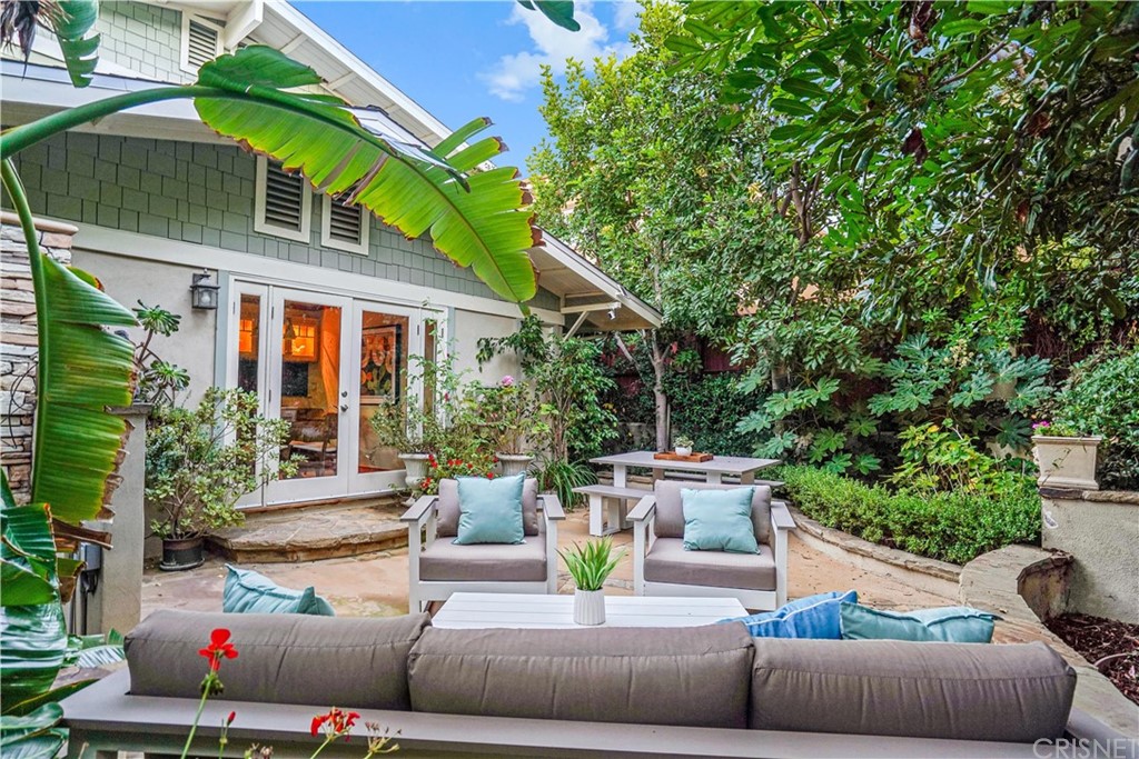15098 Rayneta Drive Sherman Oaks, CA 91403 - Photo 40 of 43 a view of a patio with couches table and chairs under an umbrella