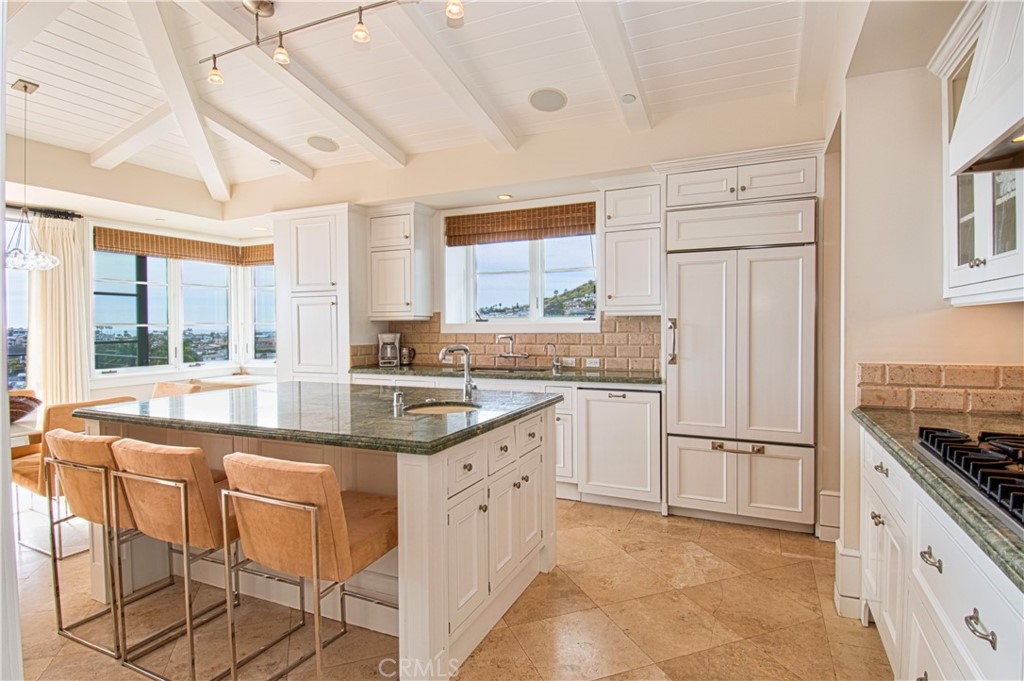 322 Emerald Bay Laguna Beach, CA 92651 - Photo 11 of 34 a kitchen with white cabinets and white appliances