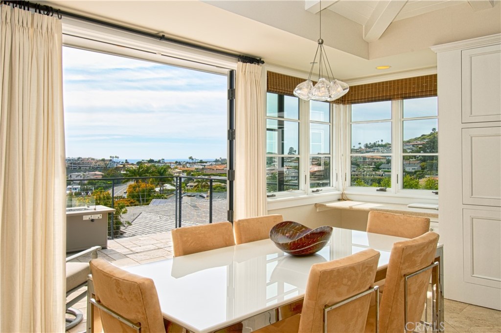 322 Emerald Bay Laguna Beach, CA 92651 - Photo 13 of 34 a dining room with furniture a chandelier and wooden floor