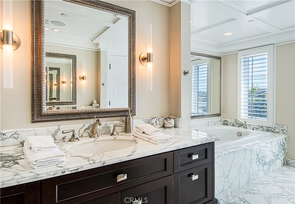 322 Emerald Bay Laguna Beach, CA 92651 - Photo 15 of 34 a bathroom with a granite countertop sink and a mirror