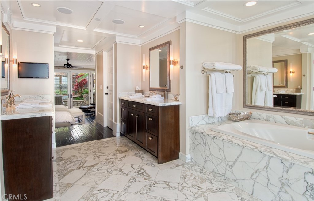 322 Emerald Bay Laguna Beach, CA 92651 - Photo 16 of 34 a en suite bathroom with a tub sink and mirror