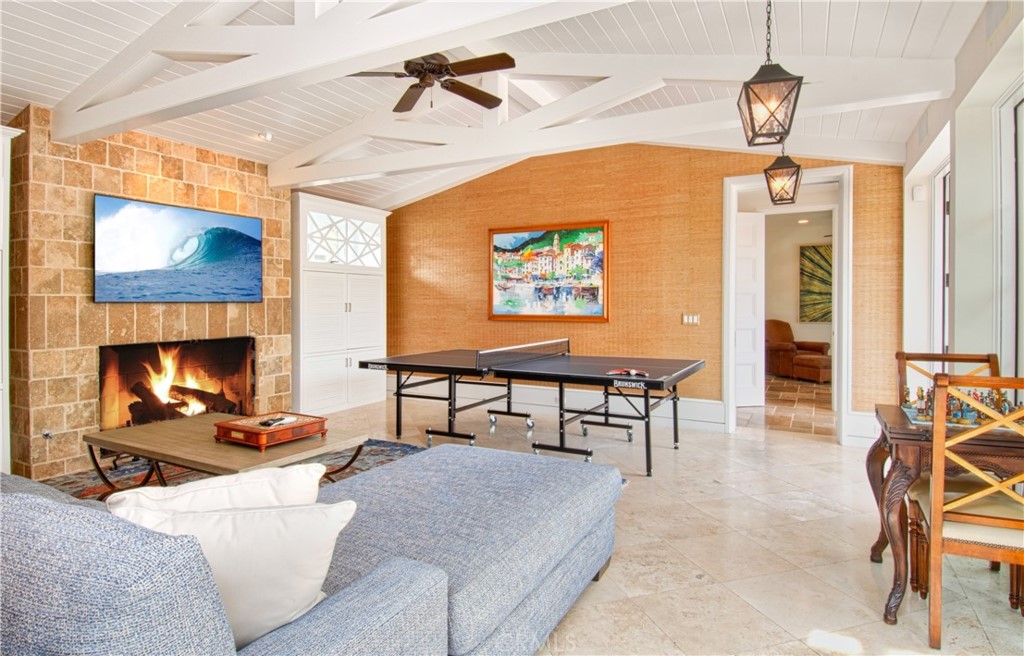 322 Emerald Bay Laguna Beach, CA 92651 - Photo 22 of 34 a living room with furniture a fireplace and a flat screen tv