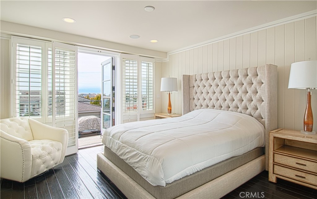 322 Emerald Bay Laguna Beach, CA 92651 - Photo 23 of 34 a bedroom with a large bed and a couch