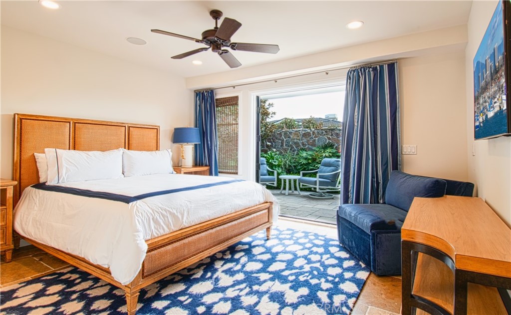 322 Emerald Bay Laguna Beach, CA 92651 - Photo 25 of 34 a bedroom with a bed and wooden floor