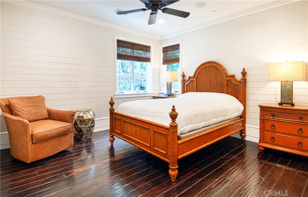 322 Emerald Bay Laguna Beach, CA 92651 - Photo 29 of 34 a bed sitting in a bedroom next to a window with a chandelier