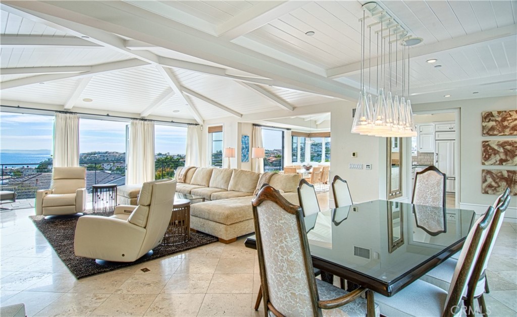 322 Emerald Bay Laguna Beach, CA 92651 - Photo 8 of 34 a living room with furniture a chandelier and a large window