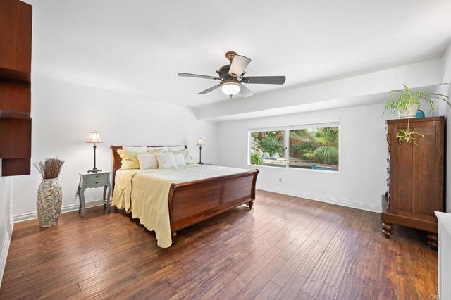 a spacious bedroom with a bed and a window