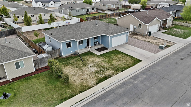 1437 925 South Vernal, UT 84078 - Photo 46 of 47 Single-story residence featuring light blue siding, a dark gray shingle roof, and a white garage door