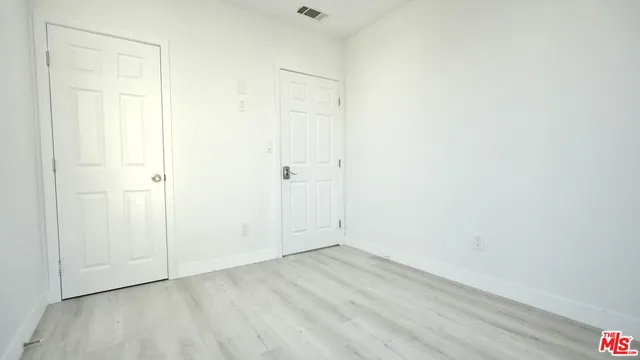 an empty room with wooden floor