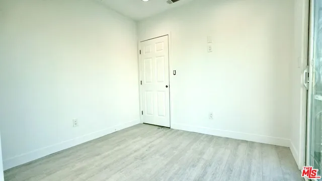 an empty room with wooden floor