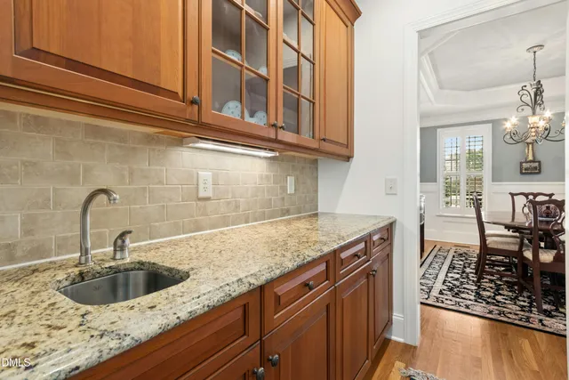 a kitchen with granite countertop a sink and cabinets