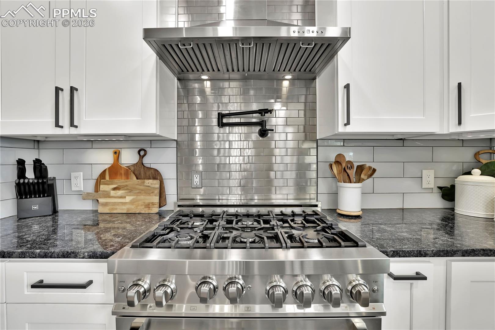 18135 Spur Ranch Road Peyton, CO 80831 - Photo 9 of 50 Custom Kitchen with gas range and hood