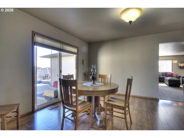 a dining room with furniture and wooden floor