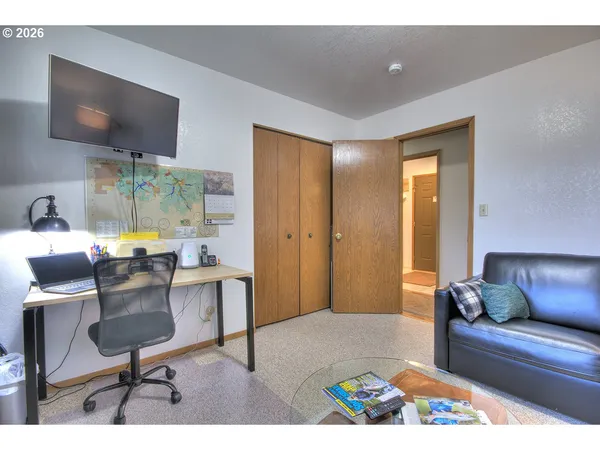 a bedroom with a bed and a dresser