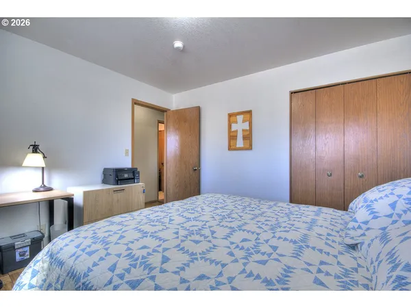 a bedroom with a bed window and book shelf