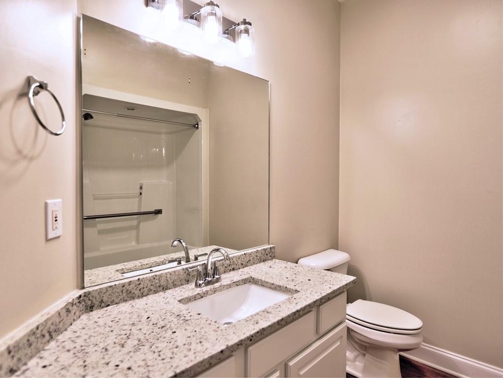 3221 Summer Stream Lane Kennesaw, GA 30152 - Photo 16 of 20 a bathroom with a granite countertop sink toilet and a mirror