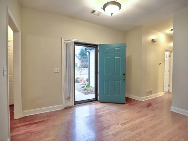 an empty room with closet and wooden floor